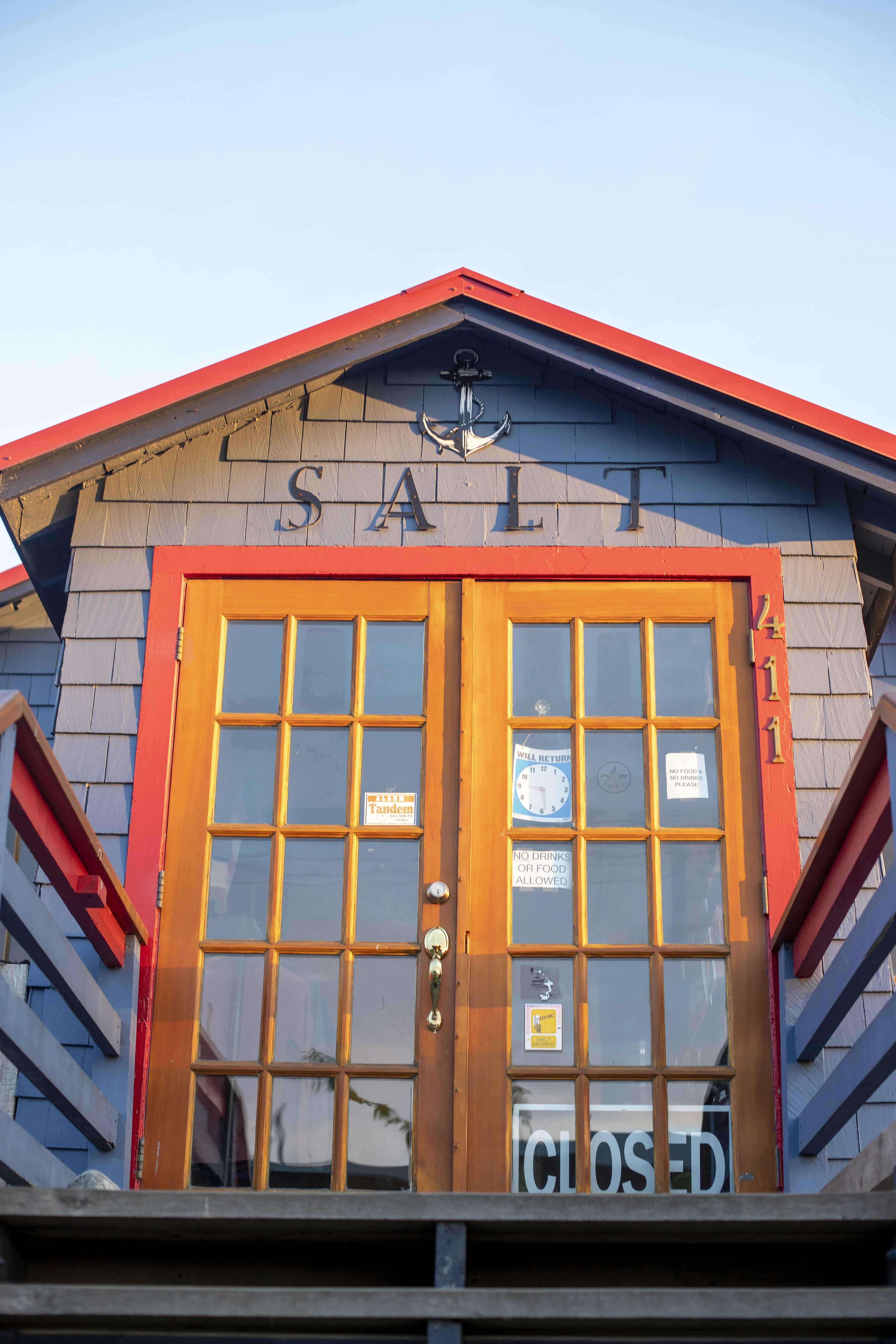 the front of a building with a wooden door