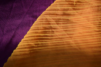 Close-up of bright, contrasting fabrics in purple, yellow, turquoise, coral, and green.