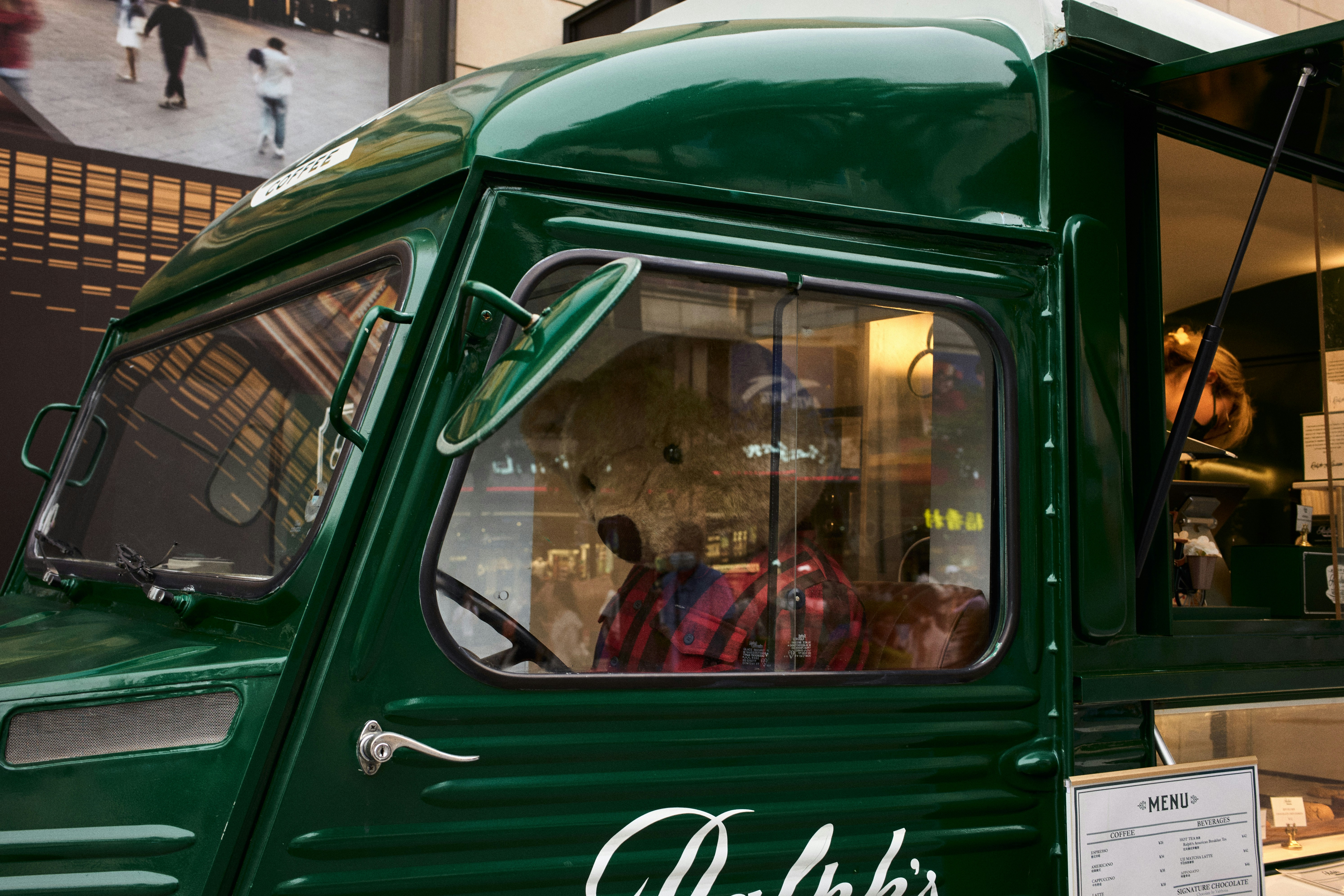 a green truck parked in front of a building