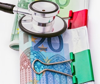 a stethoscope sitting on top of a pile of money