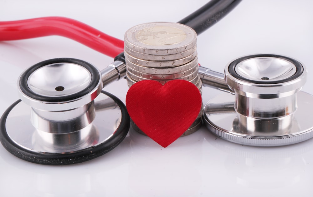 a stethoscope with a red heart on top of it