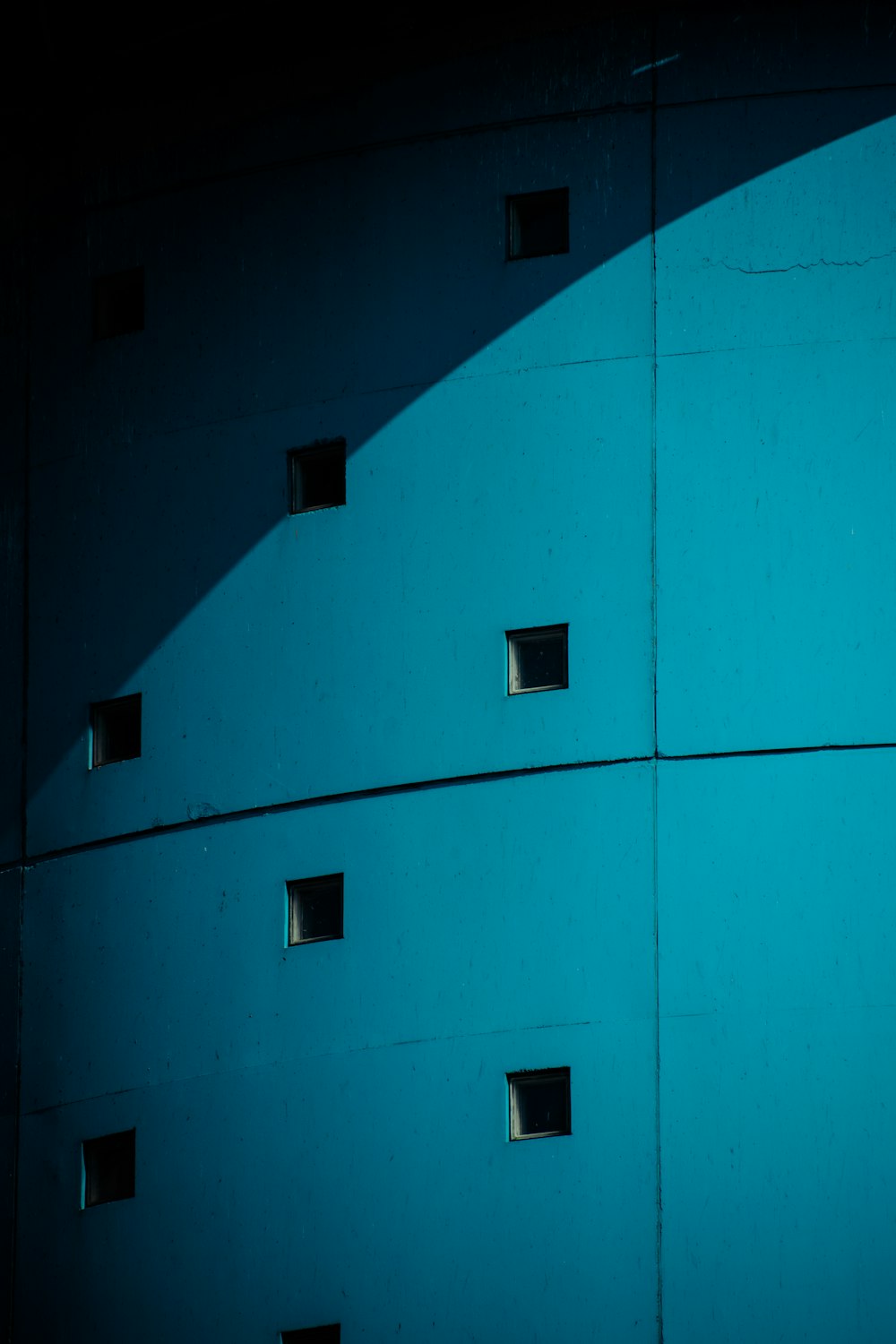 a blue wall with a bunch of holes in it