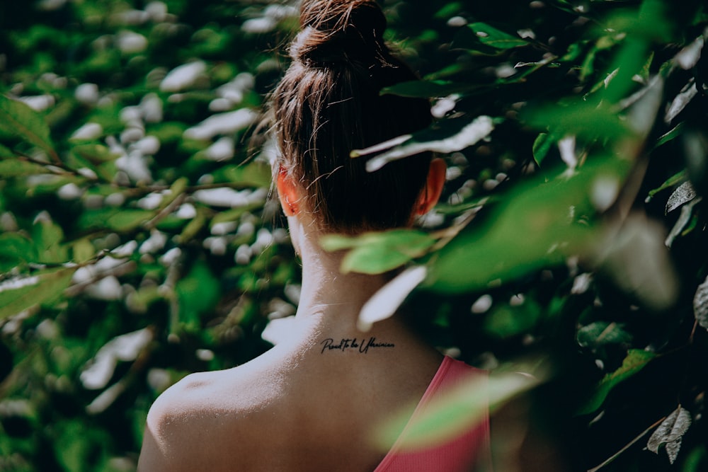 a woman with a small tattoo on her neck