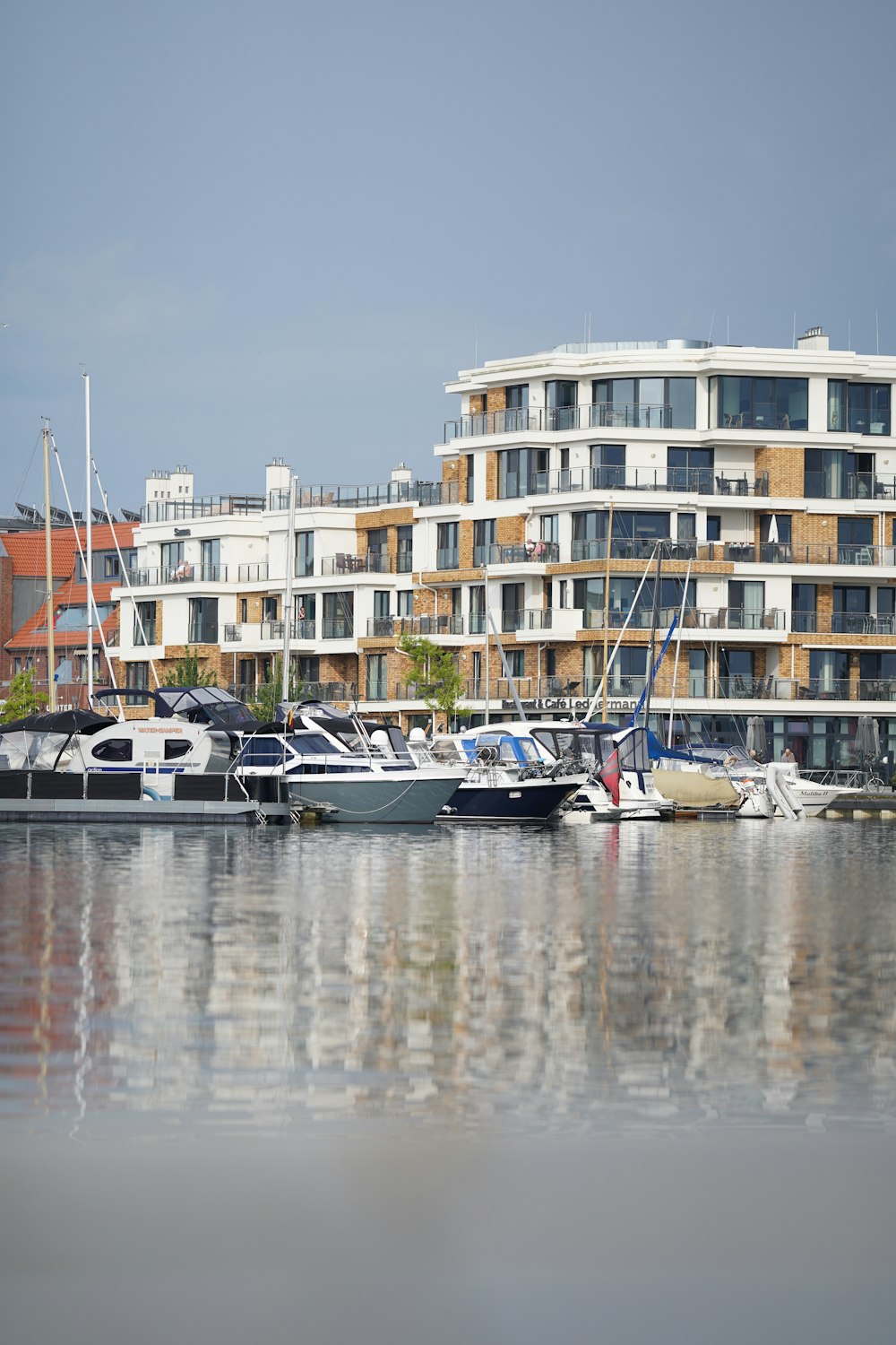 a group of boats parked in a harbor next to a building