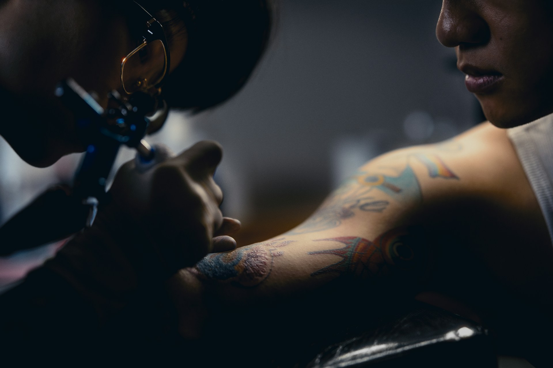a man getting a tattoo on his arm
