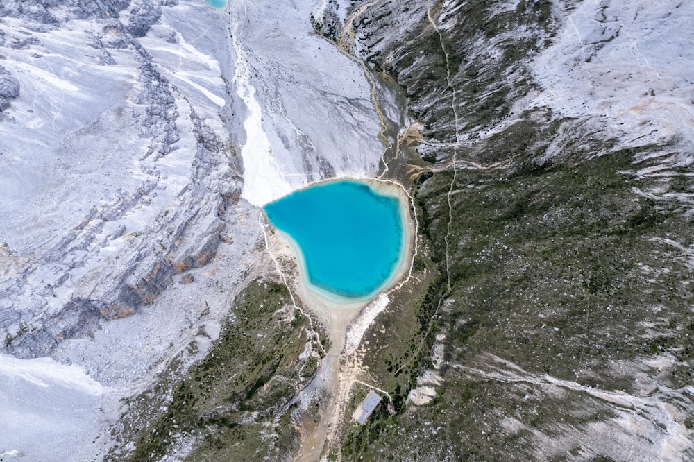 a blue lake in the middle of a mountain range