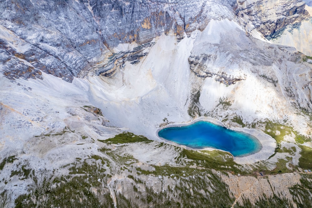 a blue lake in the middle of a mountain range