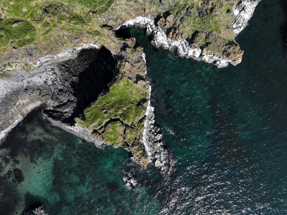 an aerial view of the ocean and cliffs