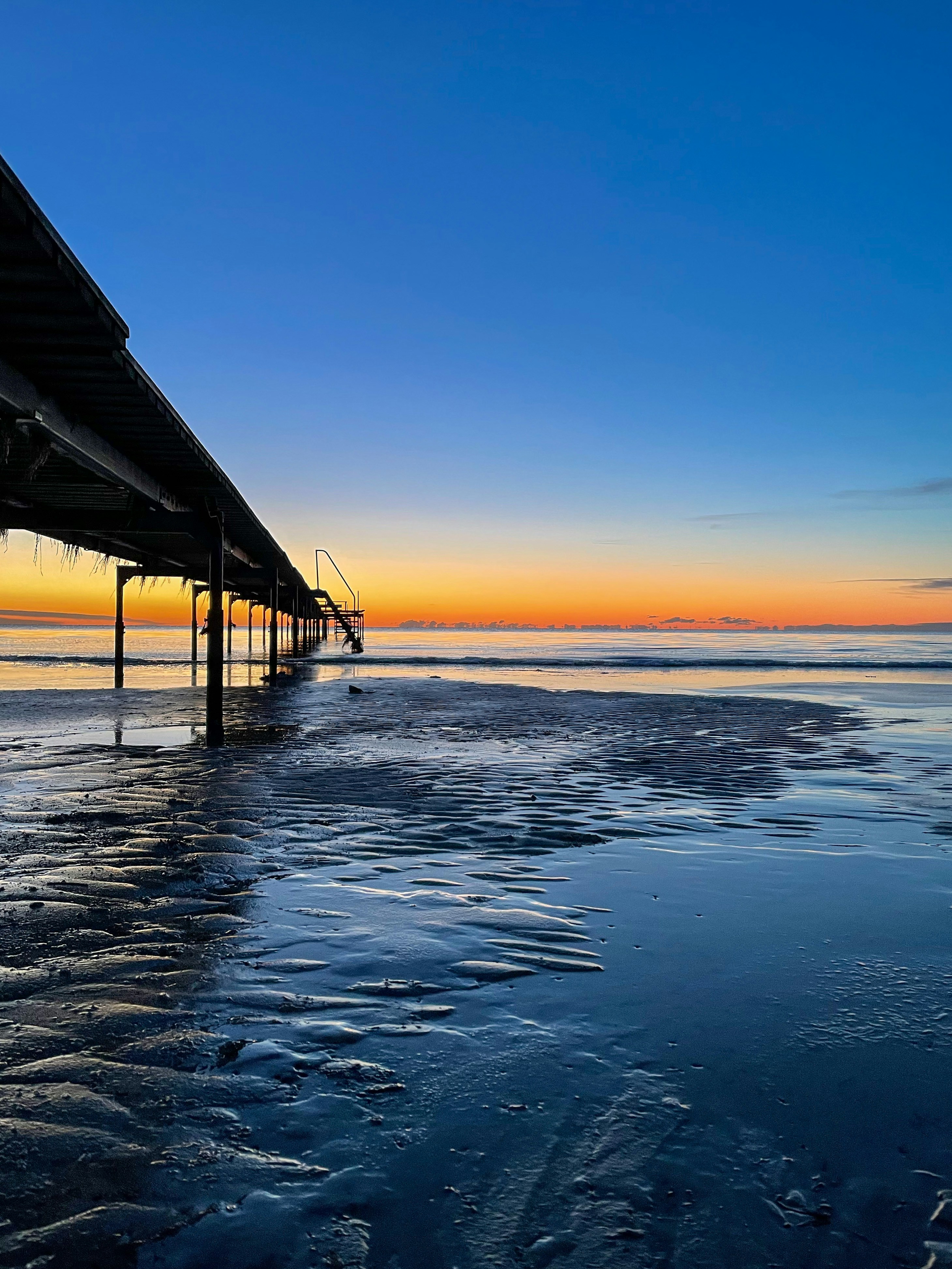 Sunset view over the Black Sea with the iconic Constanța pier in the foreground.