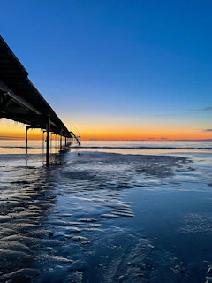 Sunset view over the Black Sea with the iconic Constanța pier in the foreground.