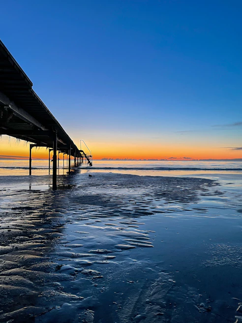 Sunset view over the Black Sea with the iconic Constanța pier in the foreground.