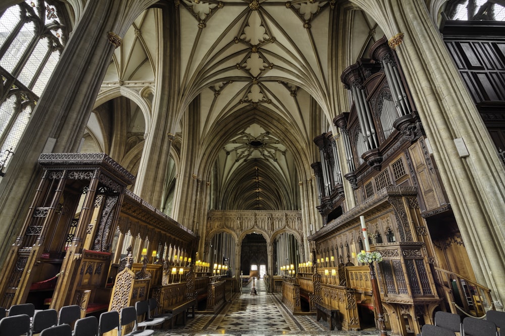 a large cathedral with pews and stained glass windows