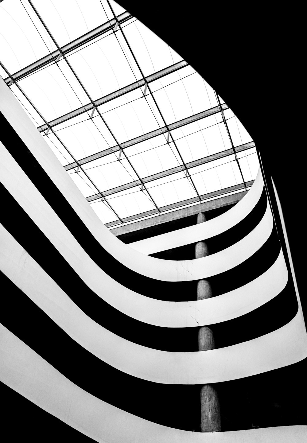 a black and white photo of a building with a skylight