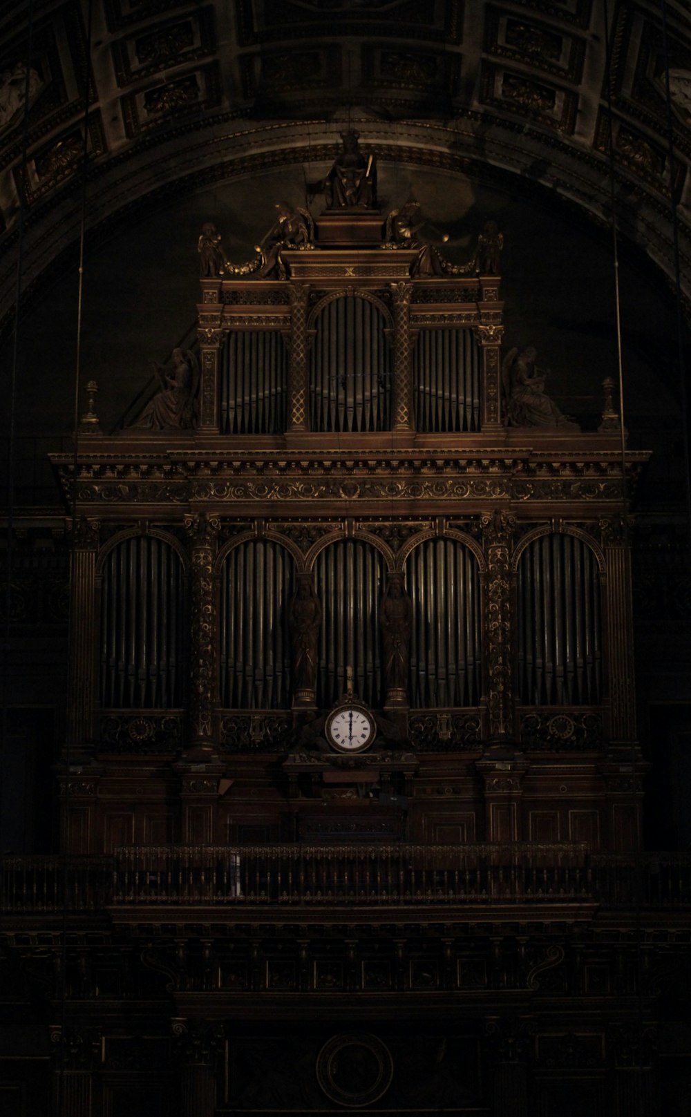 a large pipe organ in a dark room