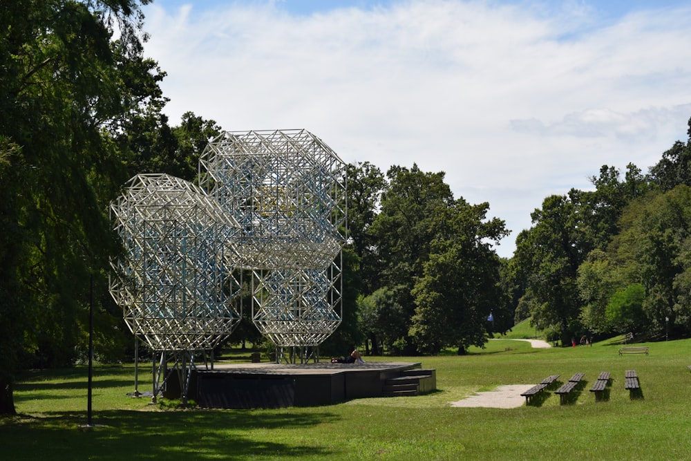 a sculpture in a park surrounded by trees