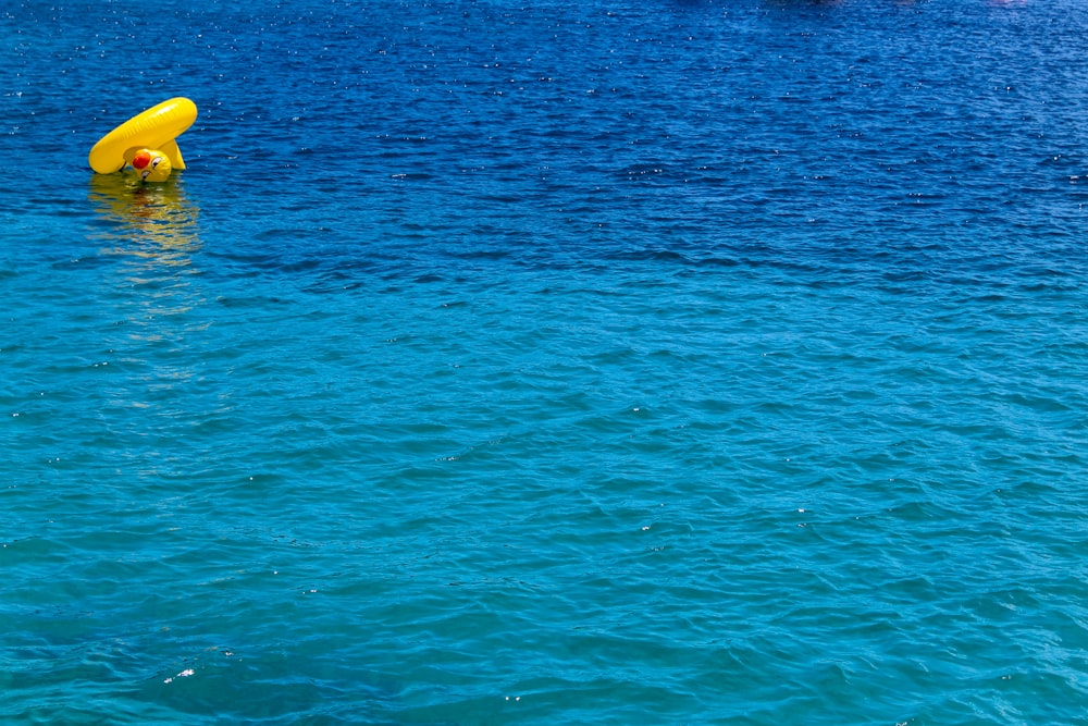 a yellow object floating in the middle of a body of water