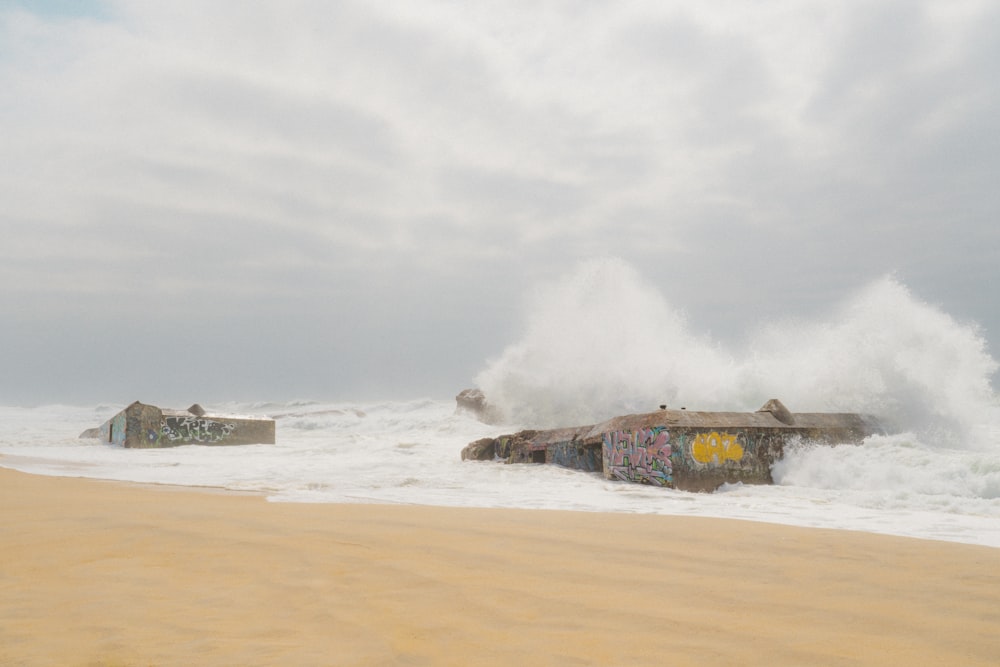 a large wave crashes over a building on the beach