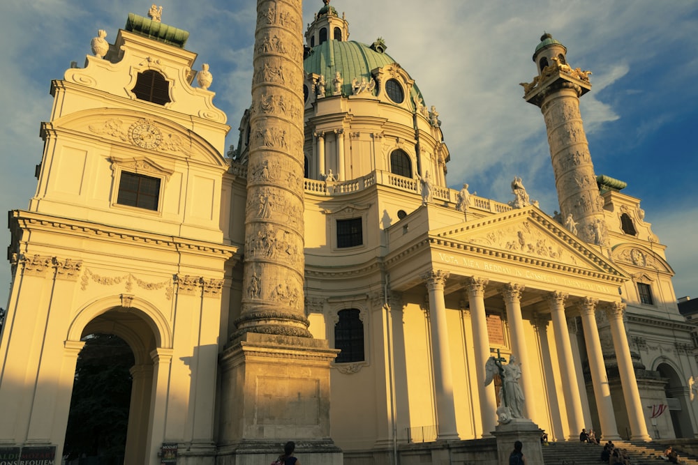 a large white building with a green dome