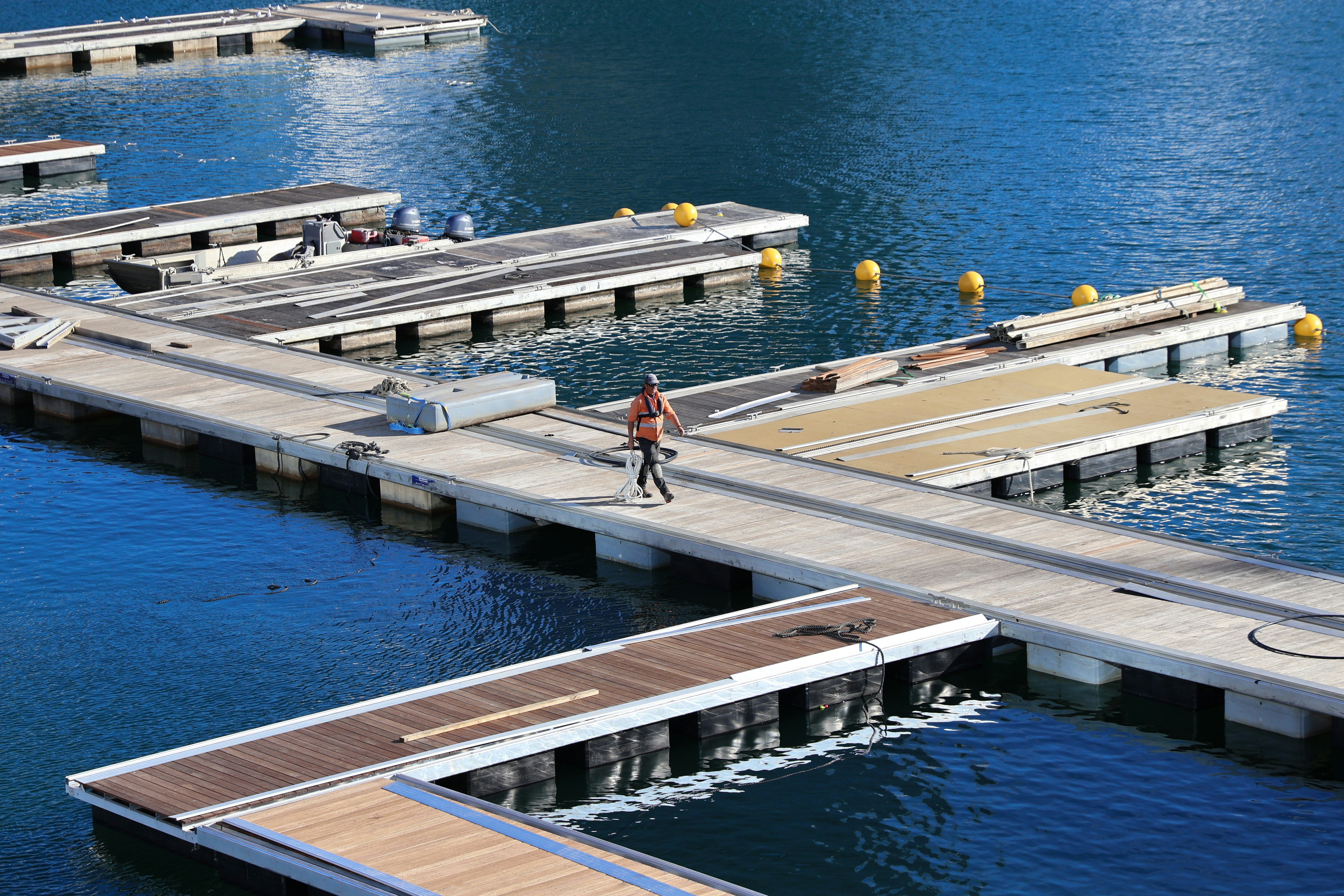 a man walking across a bridge over a body of water