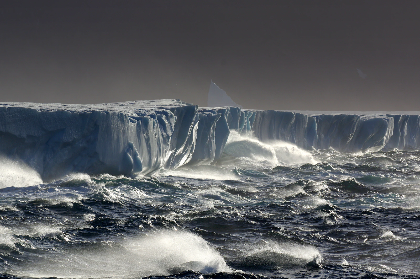 A large iceberg floating in the ocean, most of its mass hidden underwater