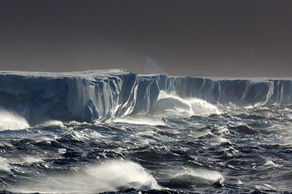 a large iceberg in the middle of the ocean