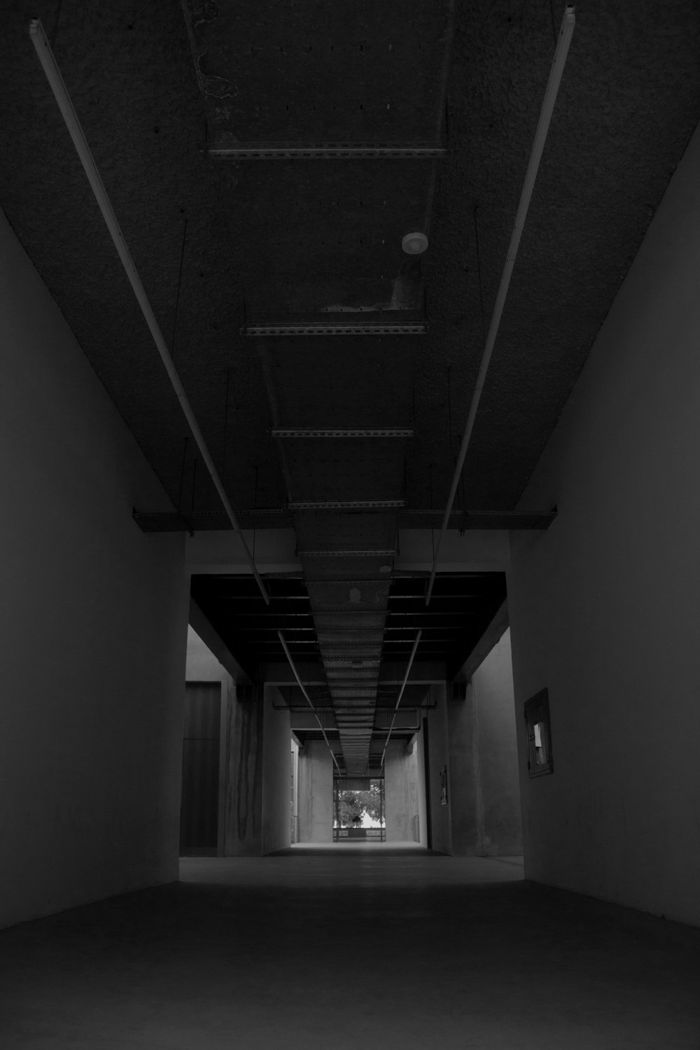 a long hallway with a light at the end of it