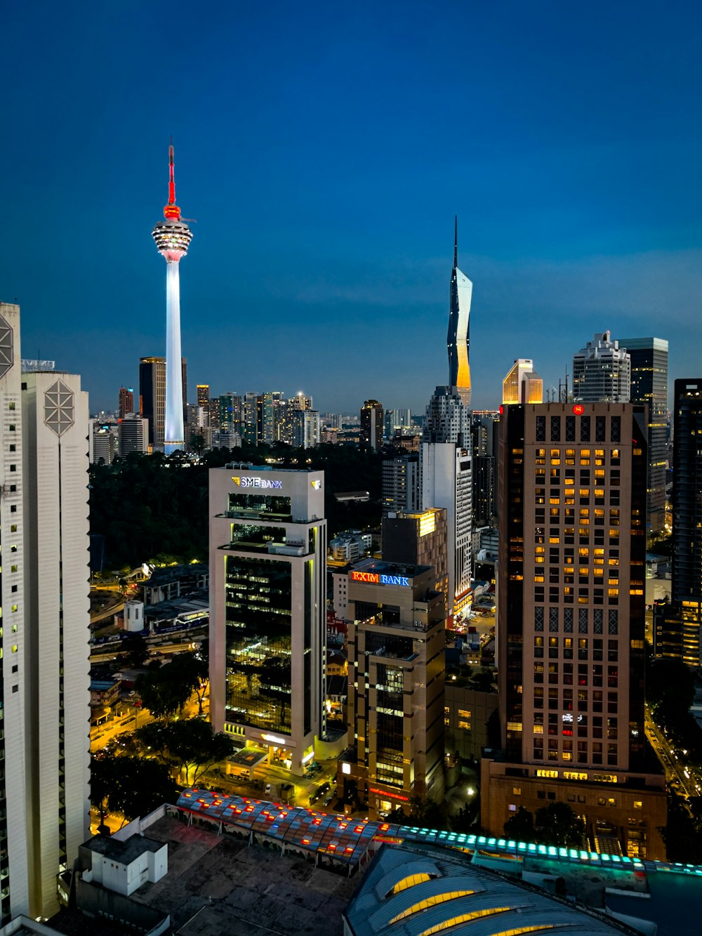 a view of a city at night with tall buildings