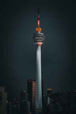 a tall tower with a sky scraper on top of it