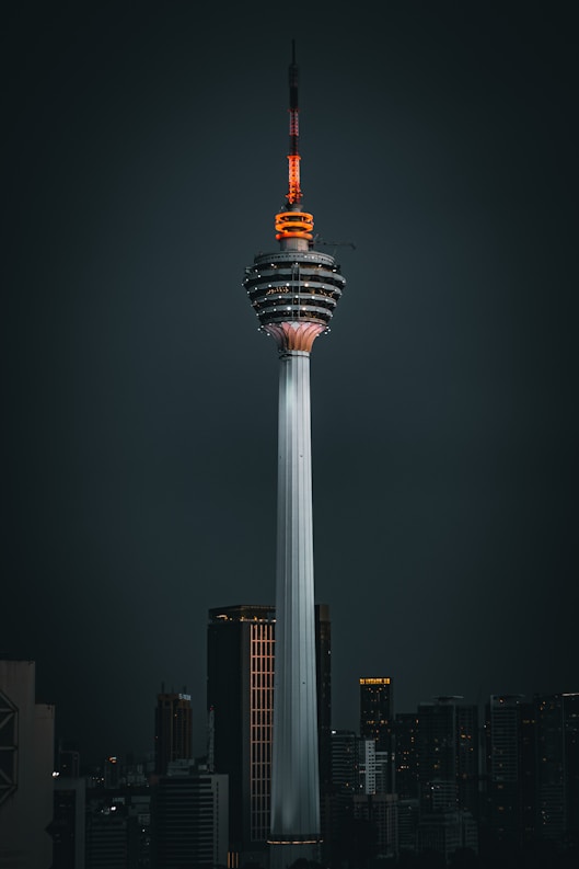 a tall tower with a sky scraper on top of it