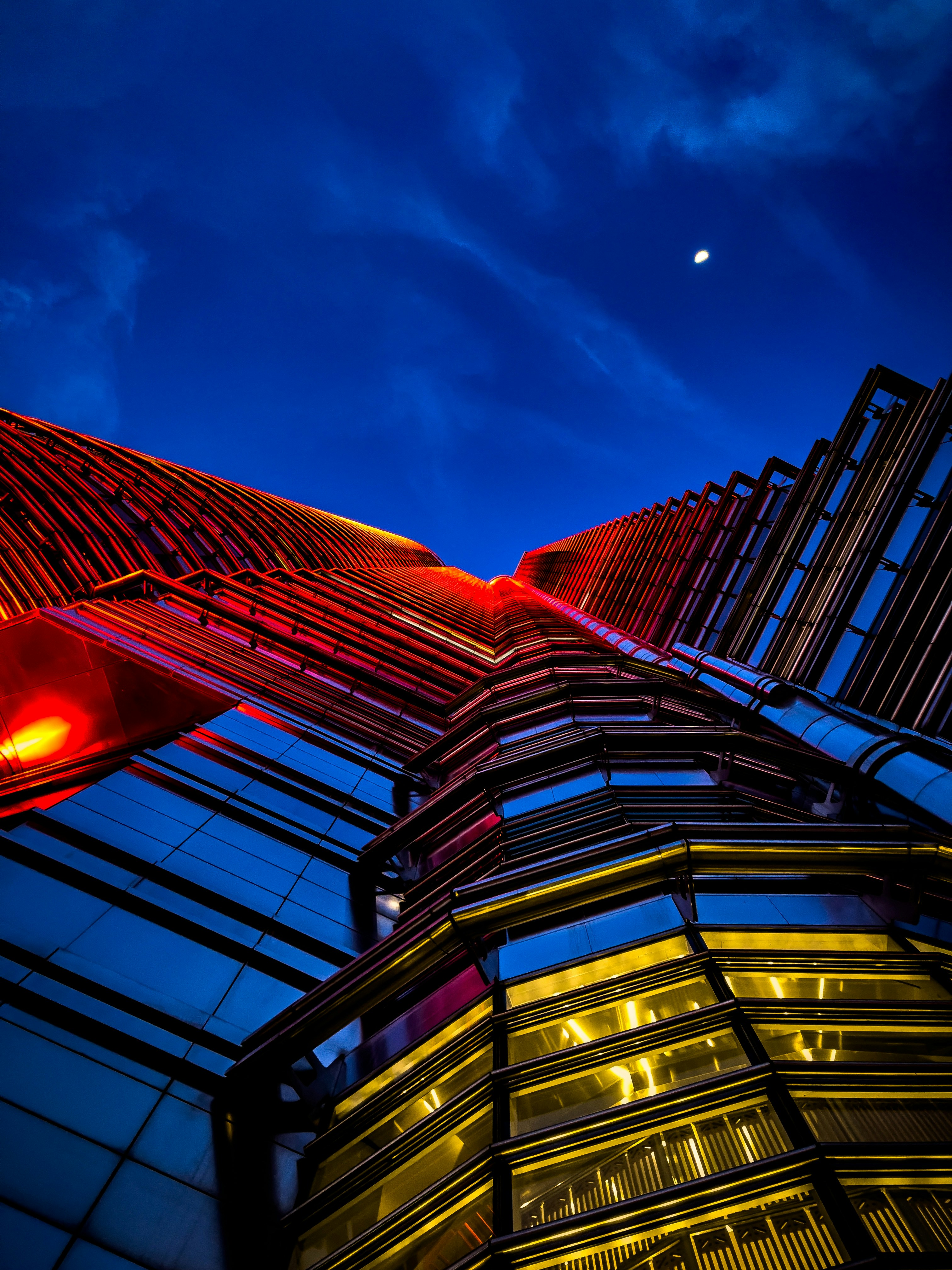 a red traffic light sitting next to a tall building