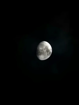 A close-up of a lunar rover exploring the moon’s surface under a dark sky.