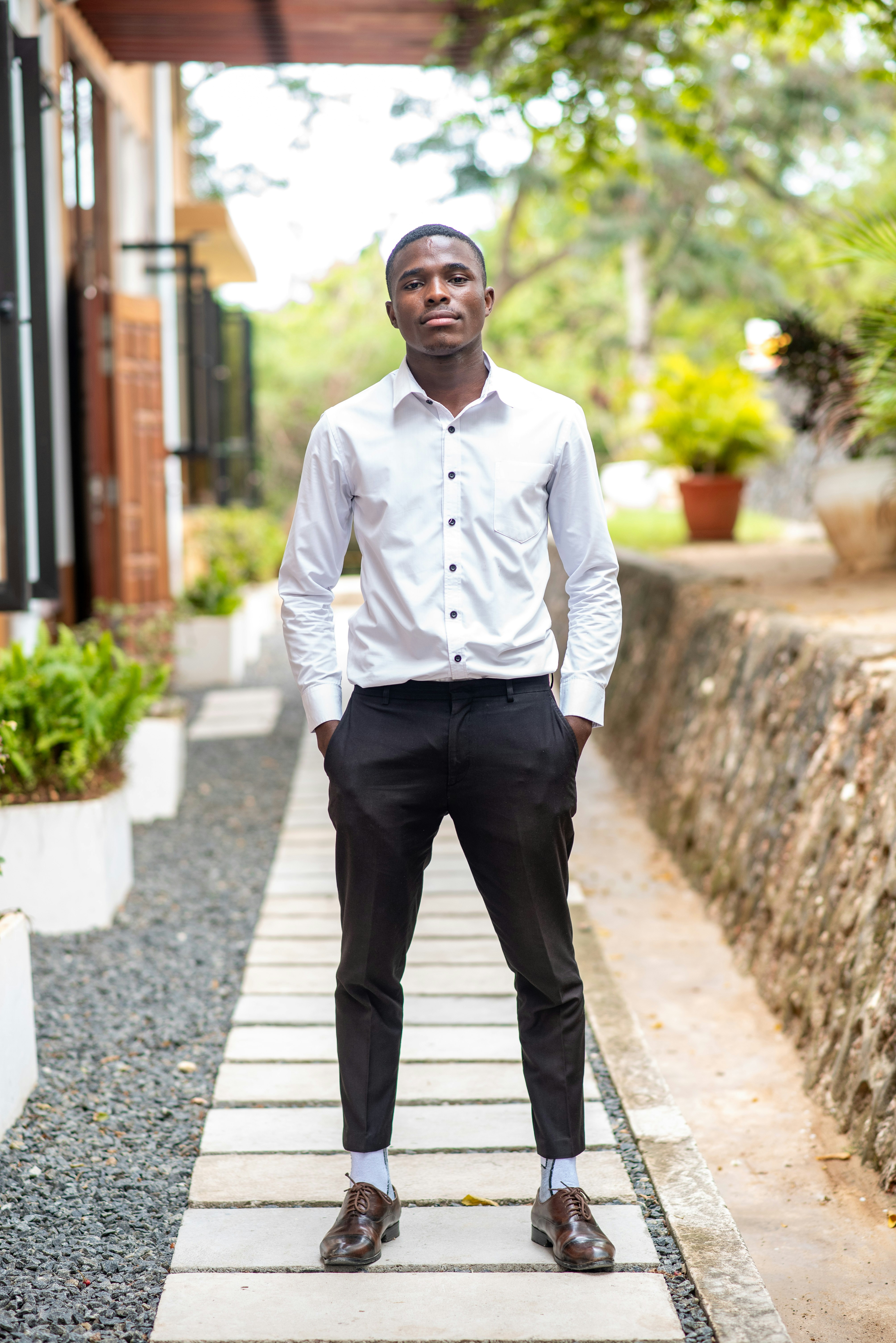 a man in a white shirt and black pants