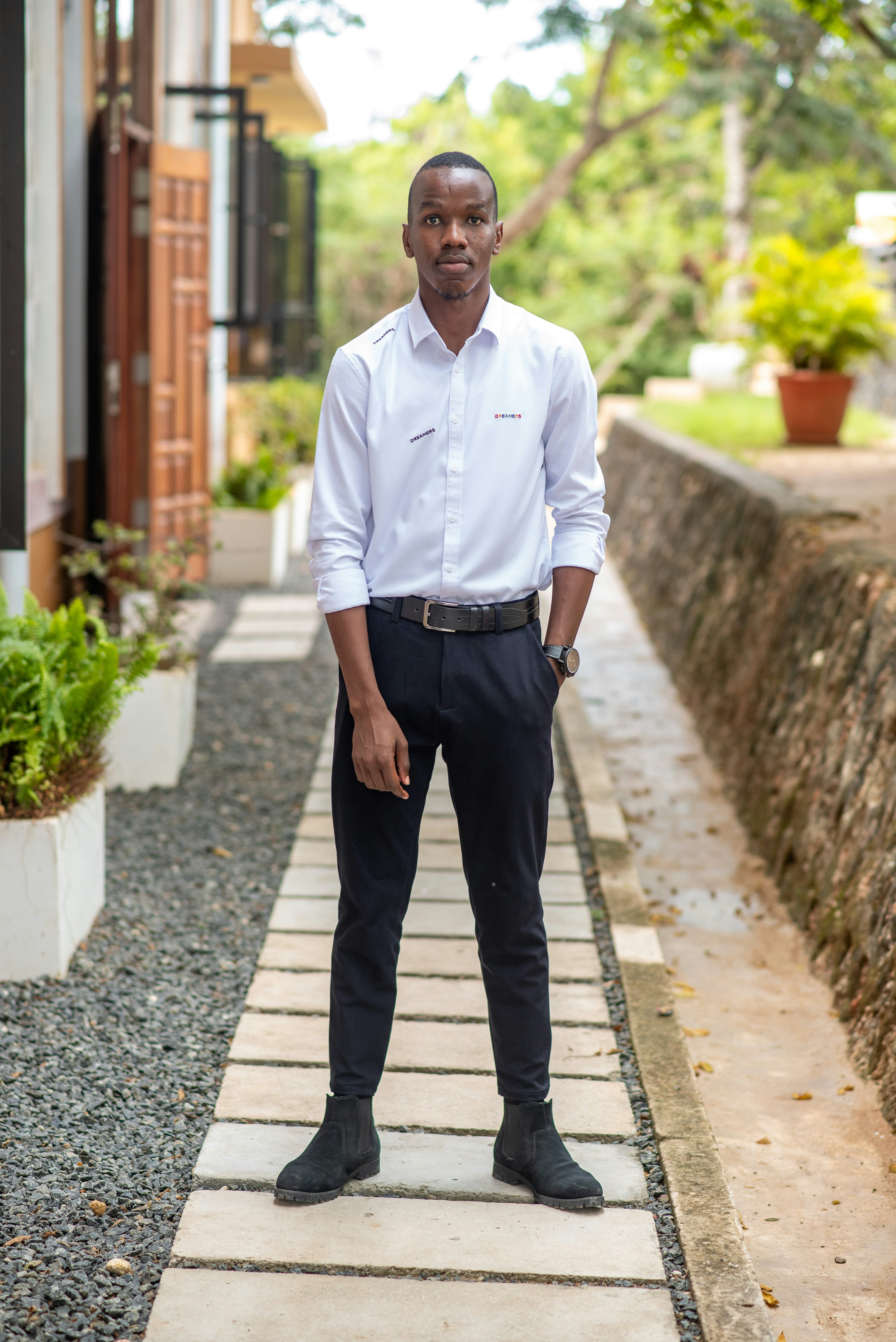 a man in a white shirt and black pants