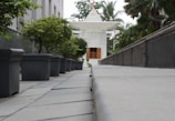 Pathway leading from the guest house to the temple grounds lined with flowering plants.