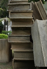 Rows of massive natural stone blocks stacked in a vast warehouse resembling a stone library.