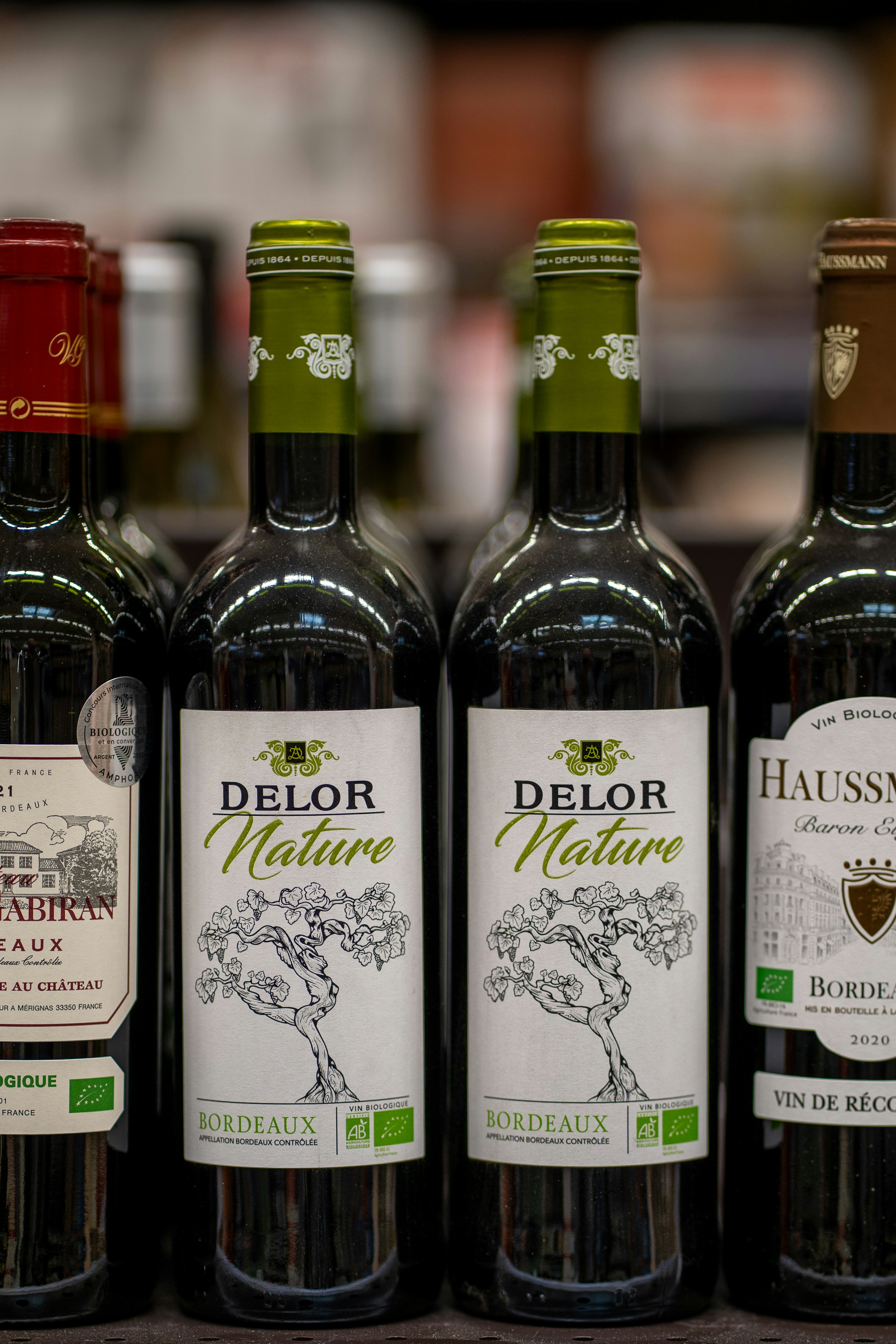 a row of wine bottles sitting on top of a counter