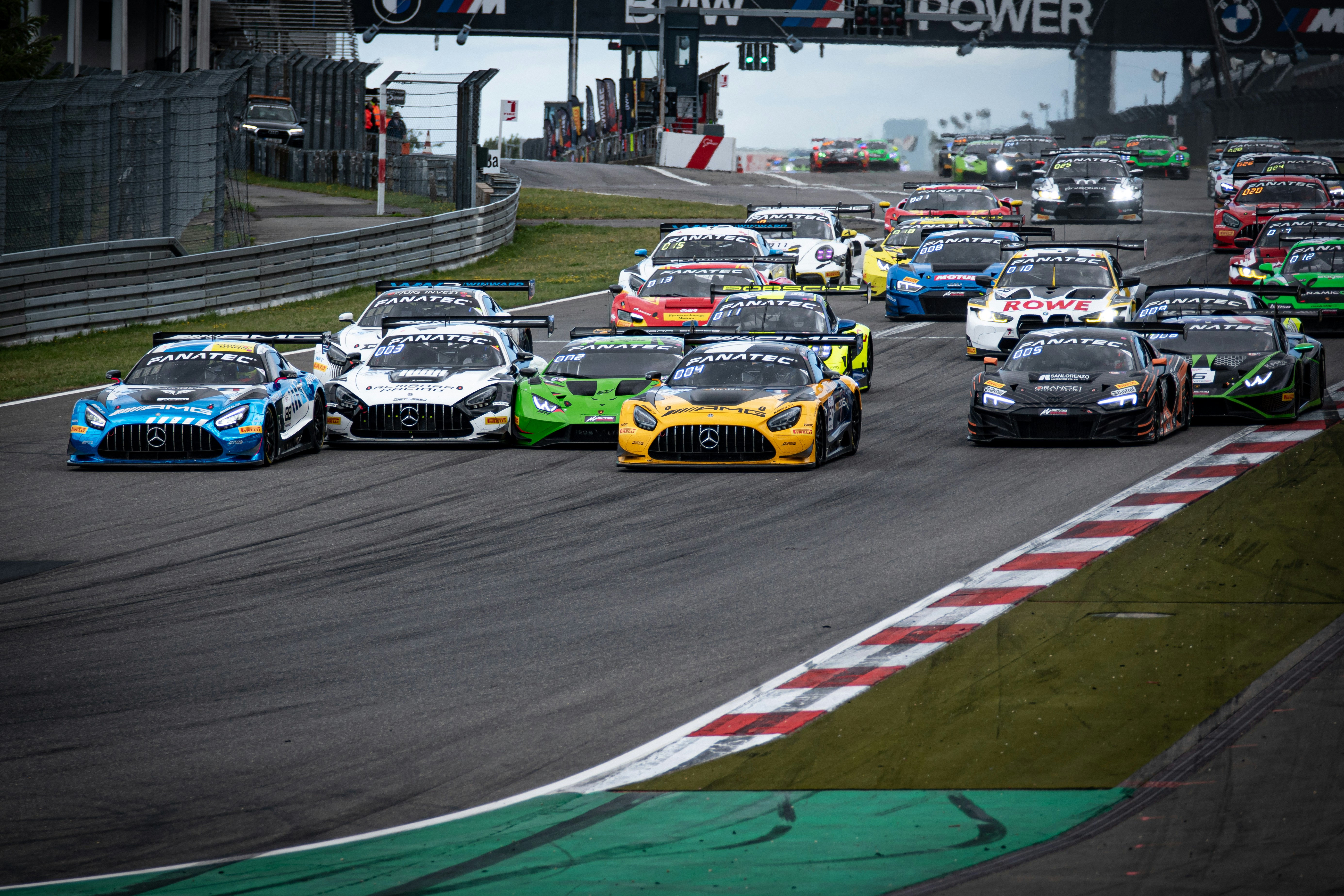 a group of cars driving down a race track