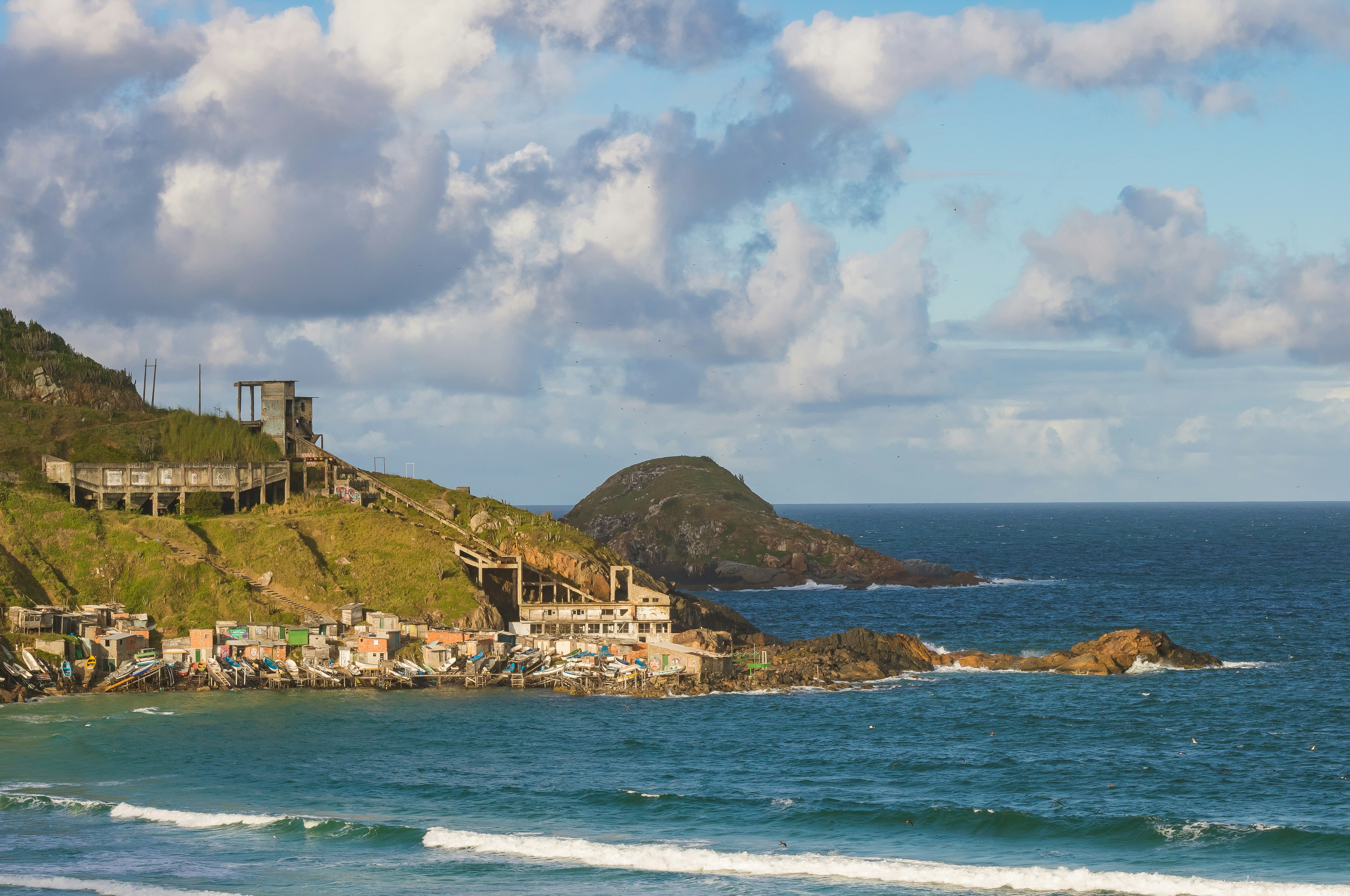a view of a beach with a hill in the background