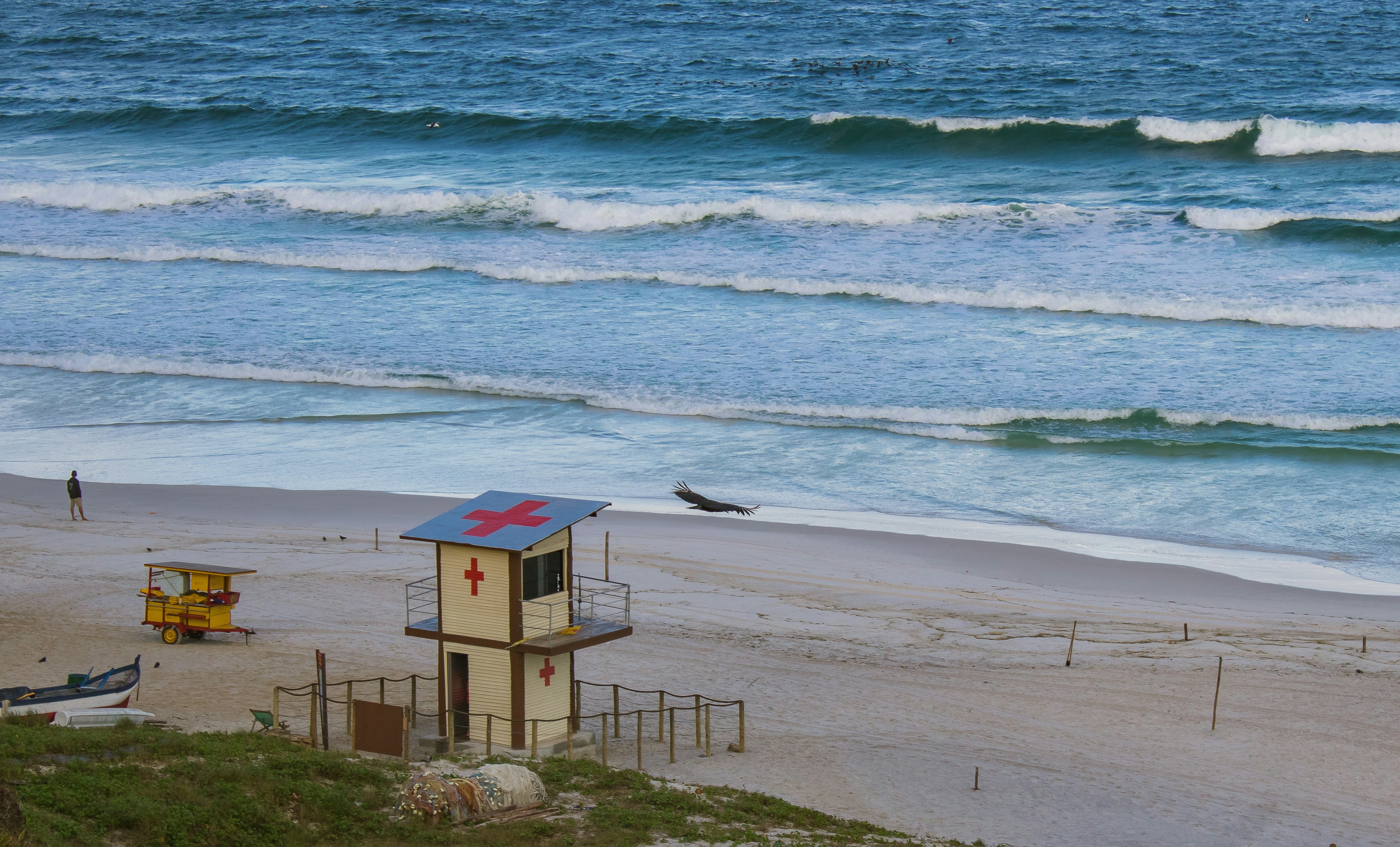 a lifeguard tower on a beach next to the ocean