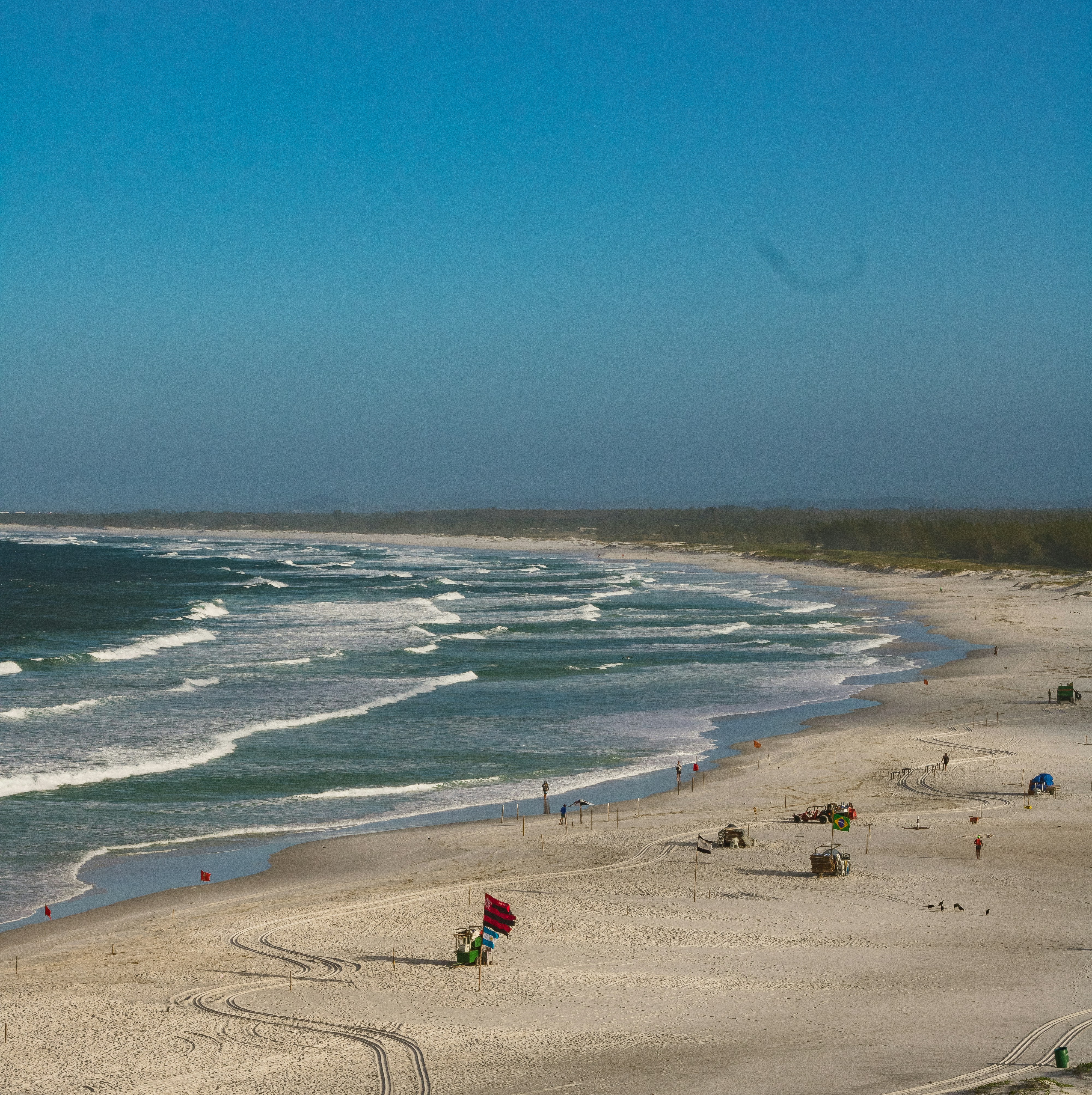 a sandy beach with waves coming in to shore