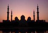 A serene view of the holy mosque during sunset, highlighting its architectural beauty.