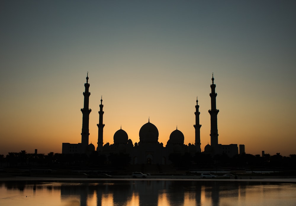 a sunset view of a large building with many spires