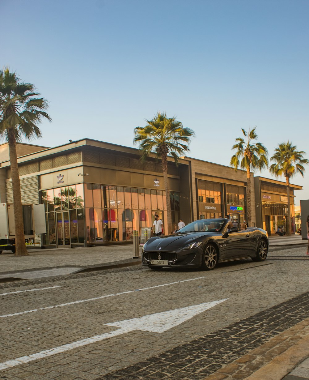 a black sports car parked in front of a building