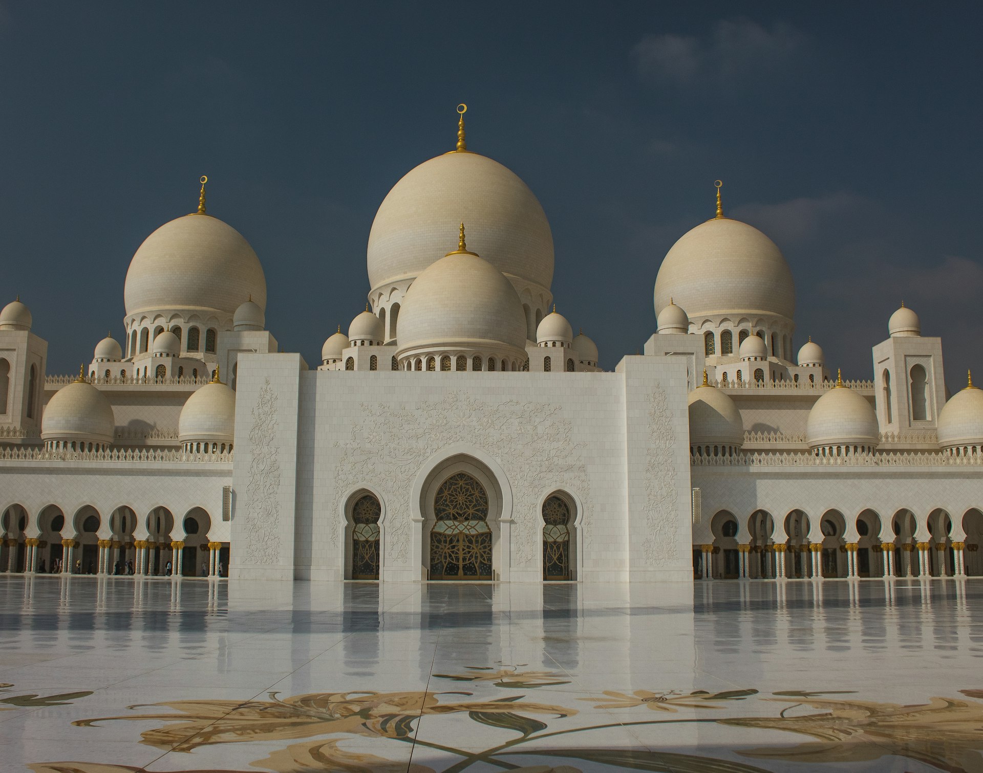 a large white building with a clock on it's side