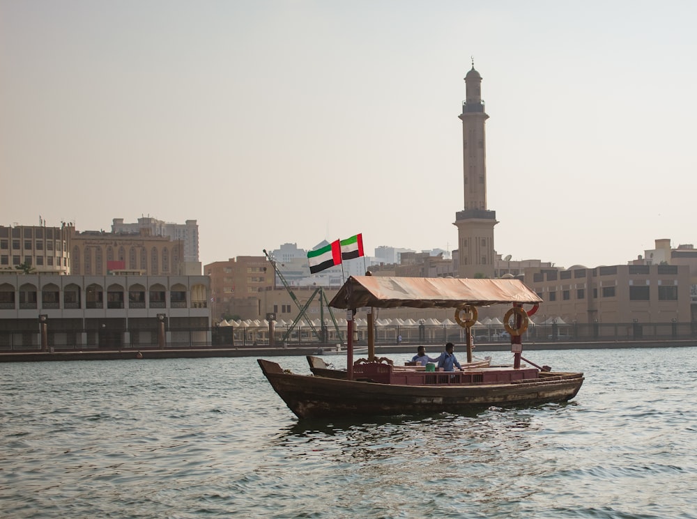 a boat with a flag on it in a body of water