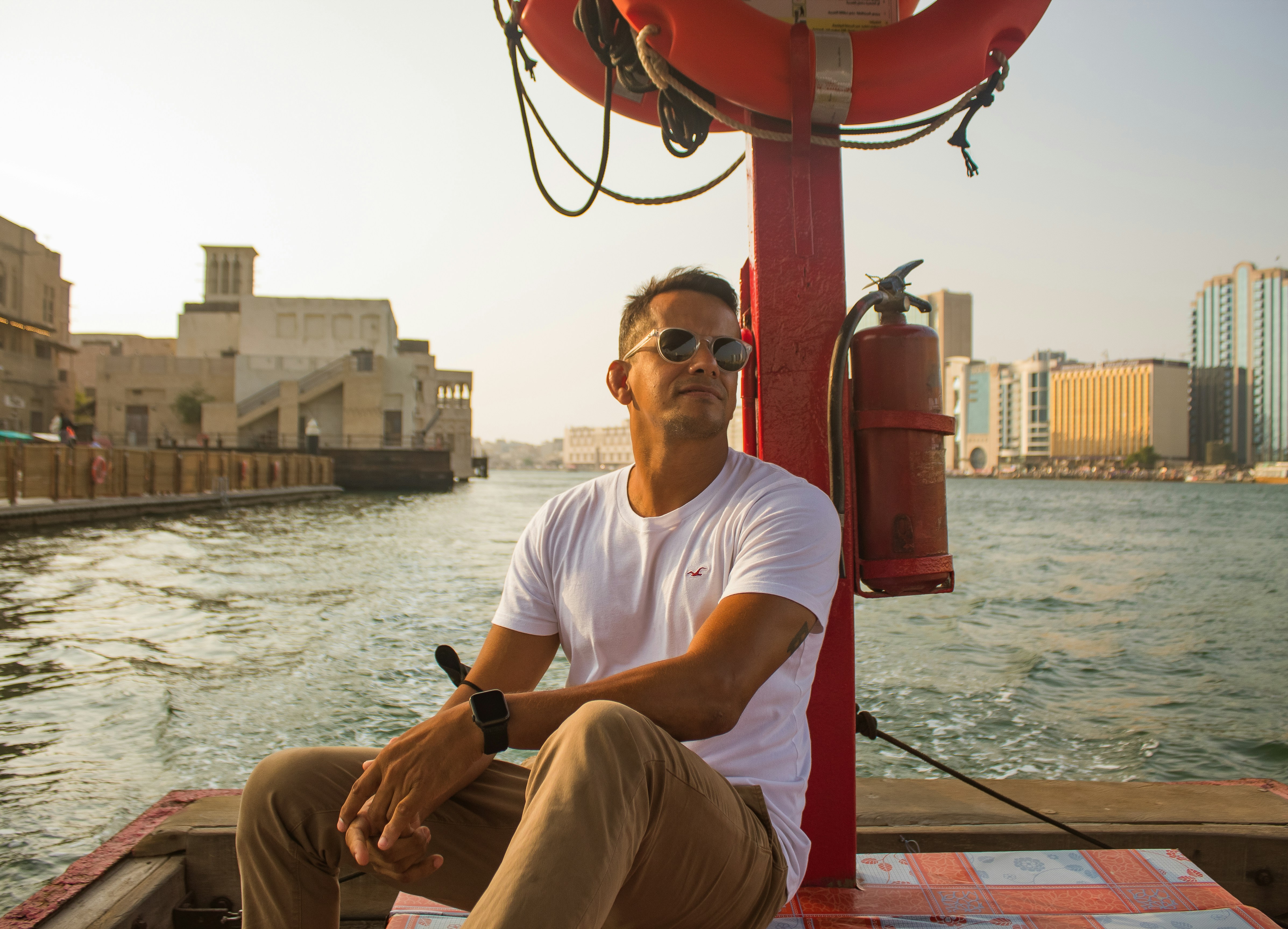 A man sitting on a boat in the water photo – Free Dubai Image on Unsplash