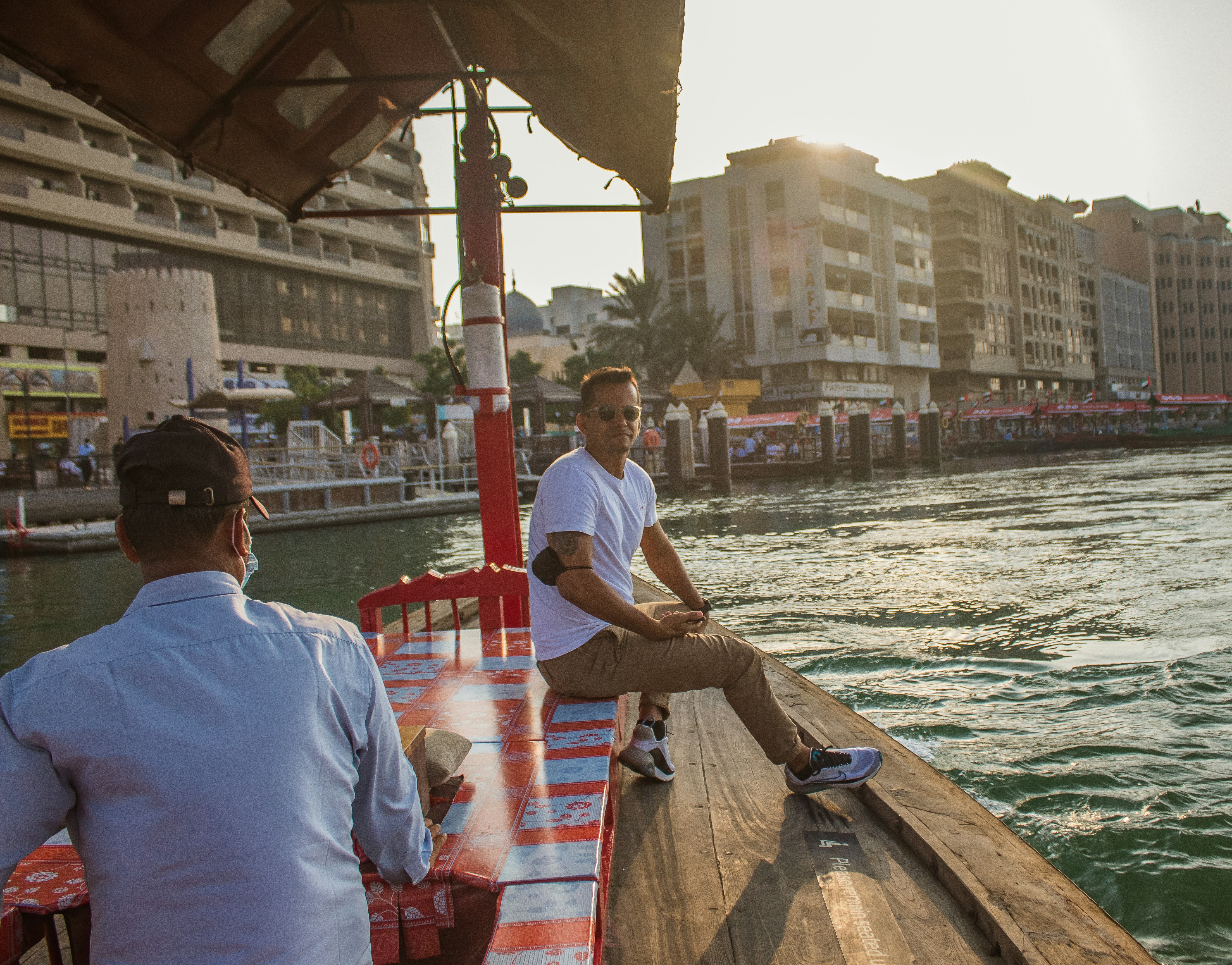 a couple of men sitting on top of a boat