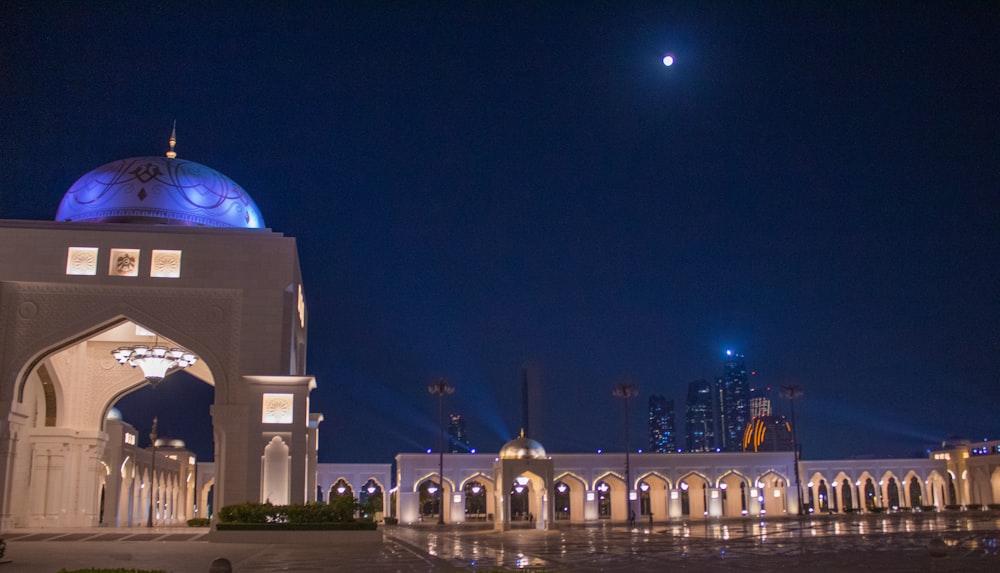 a large white building with a blue dome on top of it