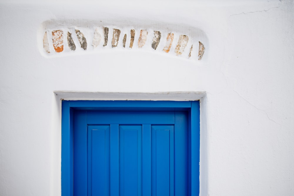 a blue door with a sign above it