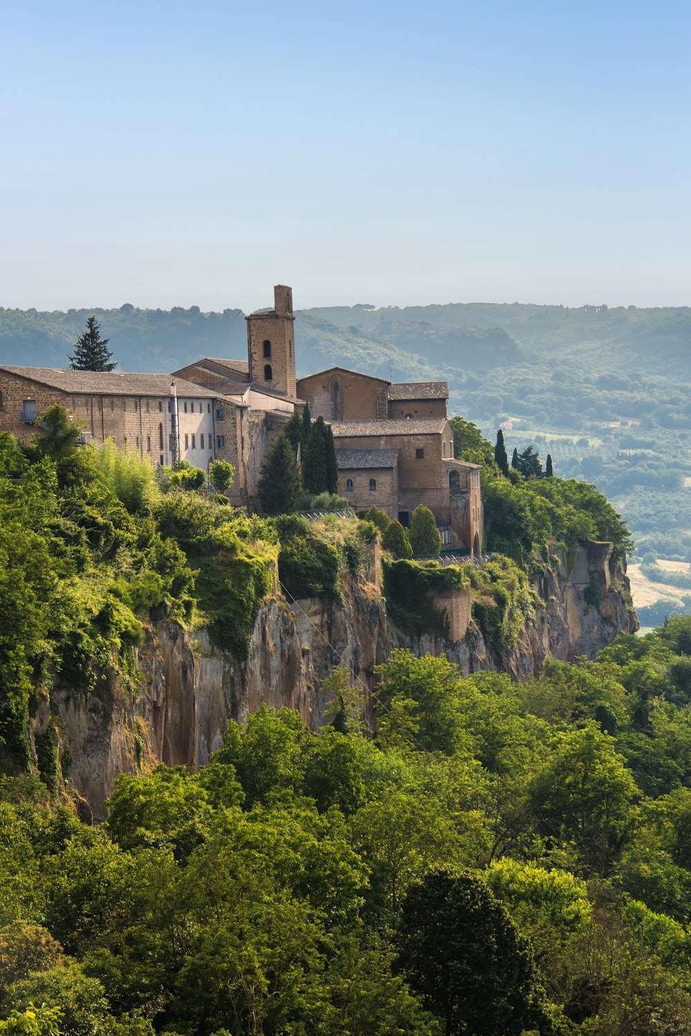 a building on top of a mountain with trees